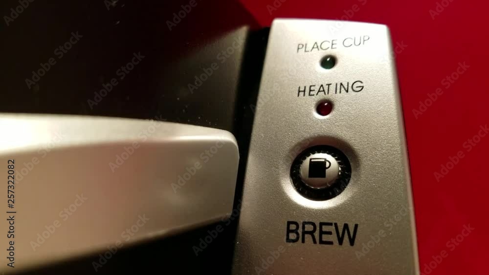 Closeup of coffee machine brewing with LED light blinking