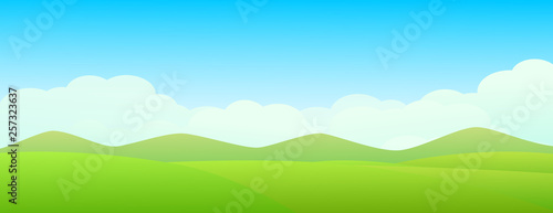 Beautiful green landscape with green meadow, mountain and blue sky