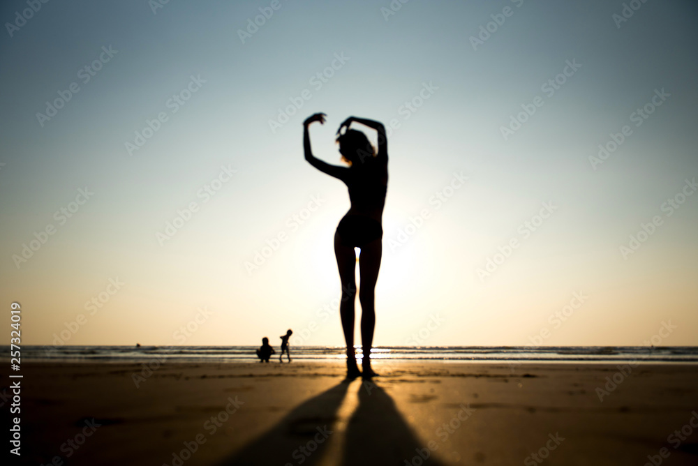 Woman on beach in sunset