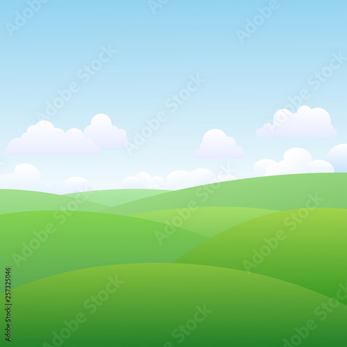 Beautiful green landscape with clouds, blue sky and green meadow