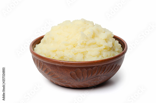 Mashed potatoes in a clay bowl. Isolate.