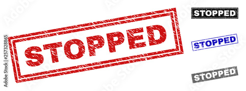 Grunge STOPPED rectangle stamp seals isolated on a white background. Rectangular seals with grunge texture in red, blue, black and gray colors.