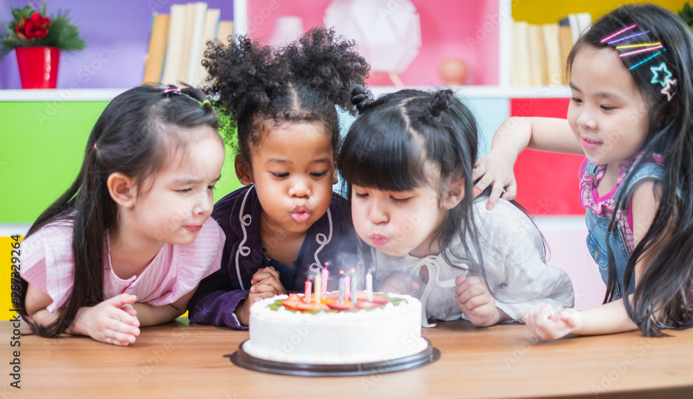 Group diversity kids blowing birth day cake. Group diversity kids blowing birth day cake.