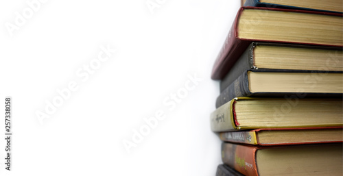 Stack of multicolored books. Old textbooks stacked on each other. Online education training skill courses concept on white background and nobody