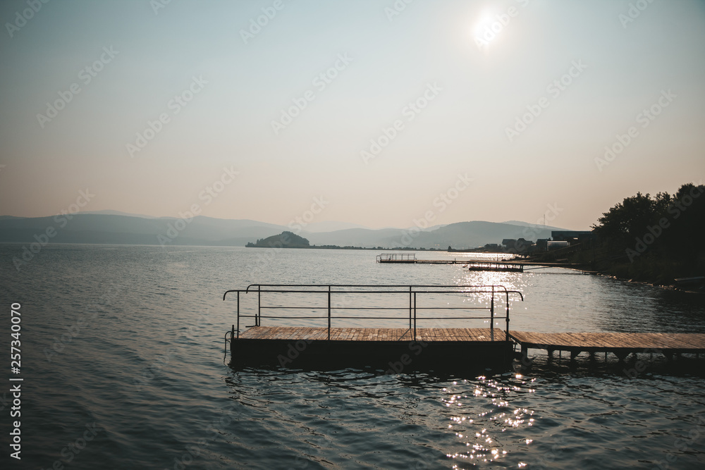 Fototapeta premium Piers along the coast in the setting sun