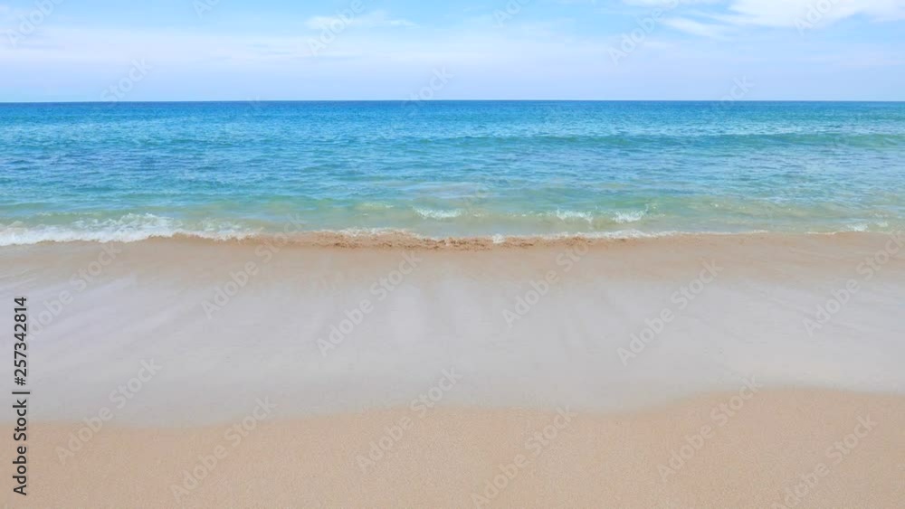 Calm beach with a clear water waves. Blue sky as background. Calm beach with a clear water waves. Blue sky as background.