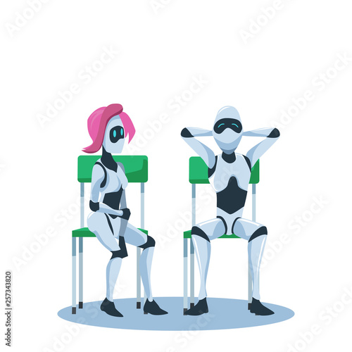 Relaxed Male and Pensive Female Robot Sit on Chair
