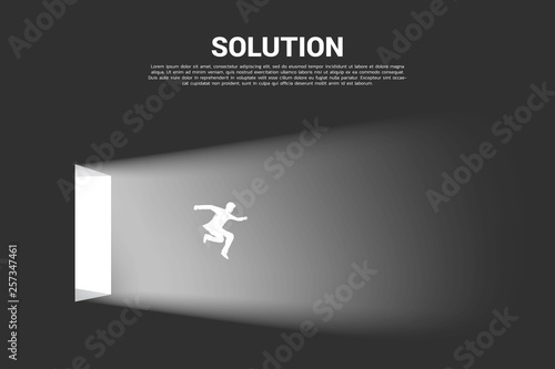 Silhouette of businessman jump out from the door of light. Concept of business direction and solution.