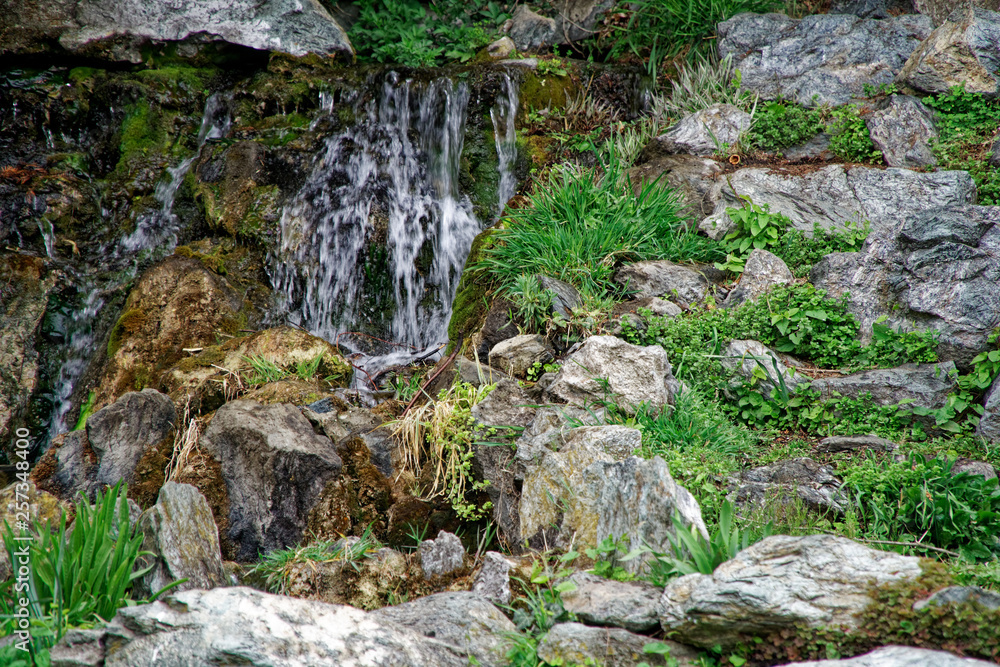 Flowing water stream, water drops and reflection Flowing water stream, water drops and reflection