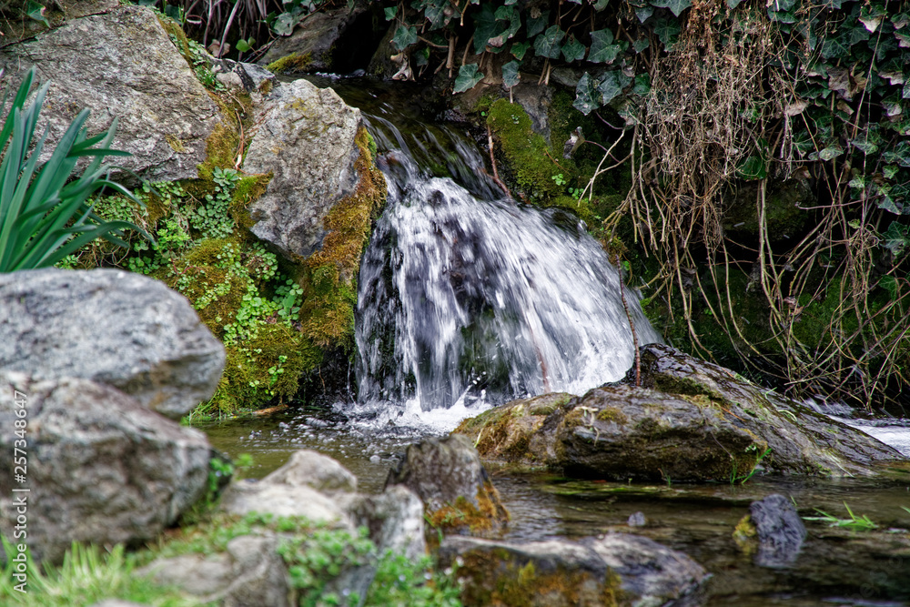 Flowing water stream, water drops and reflection Flowing water stream, water drops and reflection