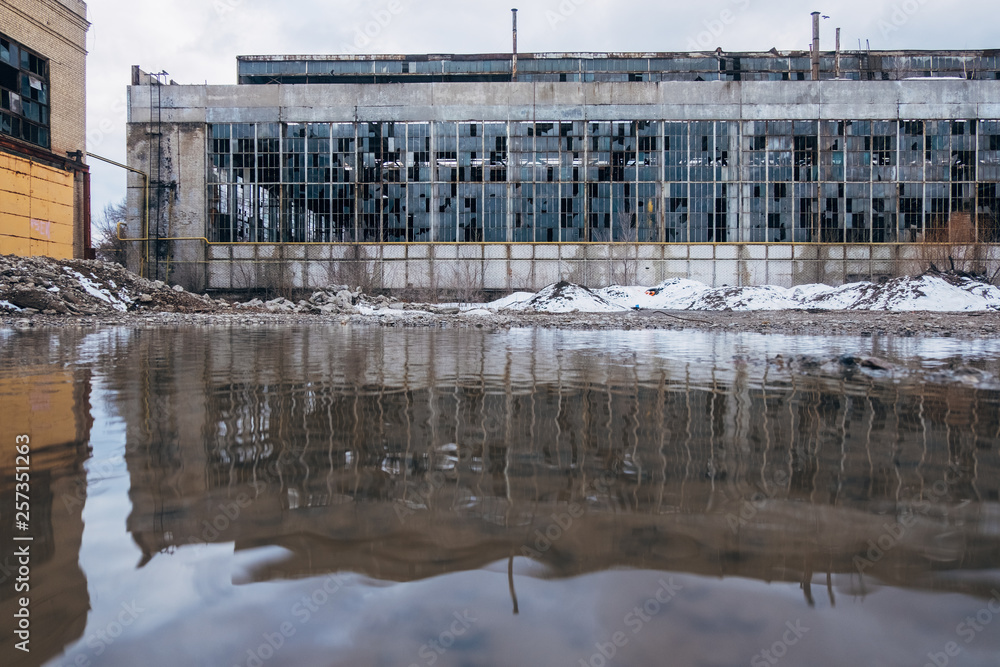 Flooded territory of abandoned factory, water reflection