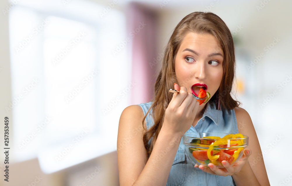 Close up portrait of woman eating salad. Close up portrait of woman eating salad.