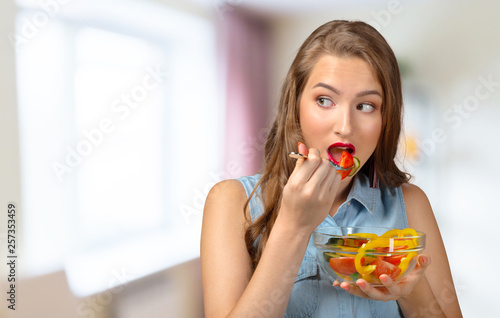 Close up portrait of woman eating salad.