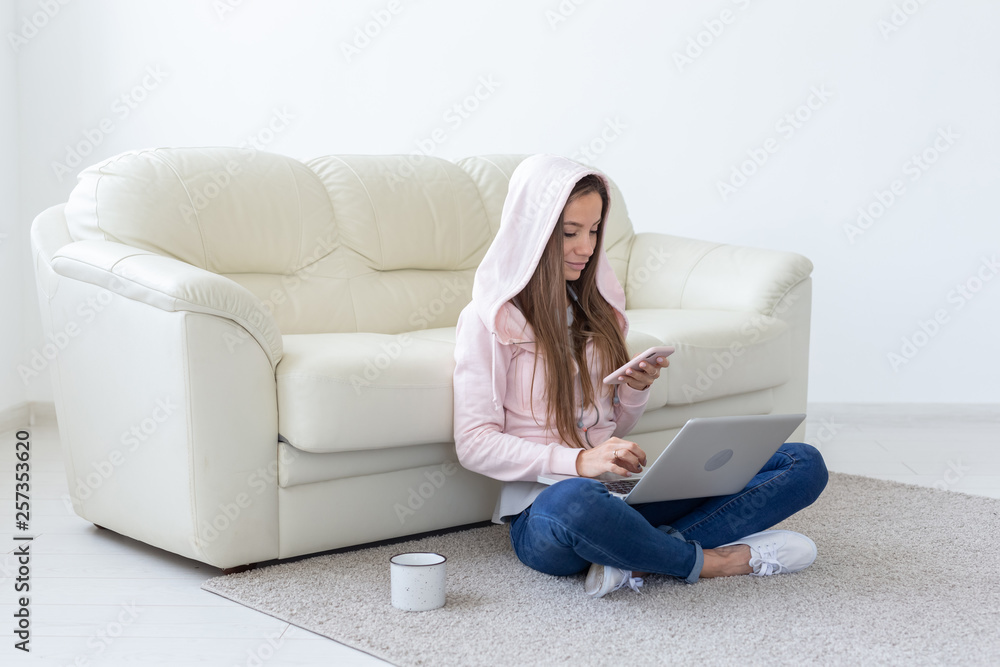 Obraz premium Working, cozy, people concept - young woman working at home, drinking tea and chatting in netbook