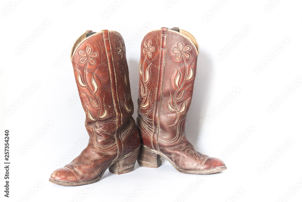 Old dirty cowboy boots on a white background Old dirty cowboy boots on a white background