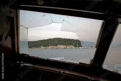 View through a broken window of an old ship