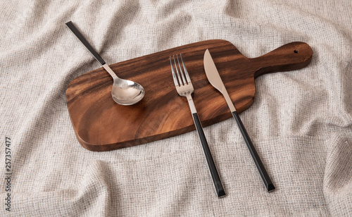 Cutlery set on a wooden cutting board
