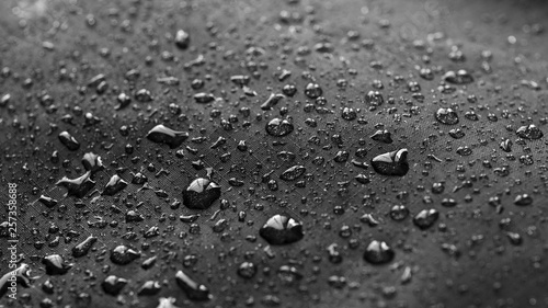 Rain Water droplets on black waterproof fabric photo
