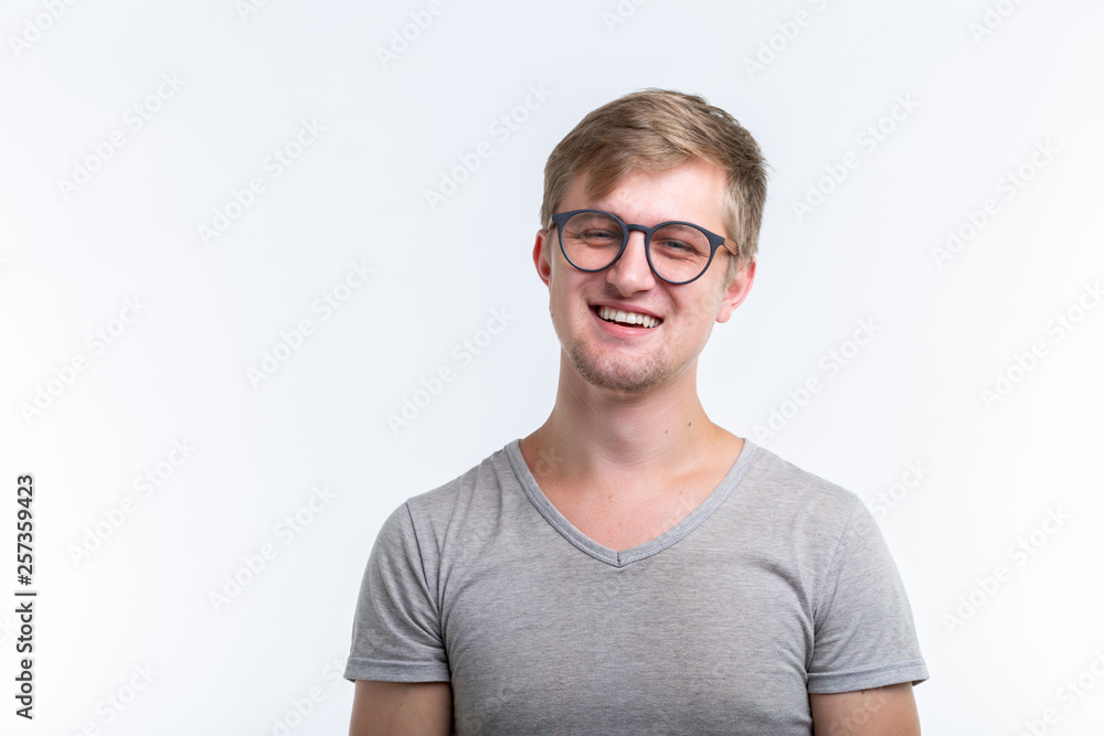 Geek, education, people concept - young man over the white background looks like he is a nerd Geek, education, people concept - young man over the white background looks like he is a nerd