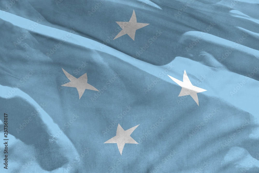 Waving Micronesia flag for using as texture or background, the flag is fluttering on the wind Waving Micronesia flag for using as texture or background, the flag is fluttering on the wind
