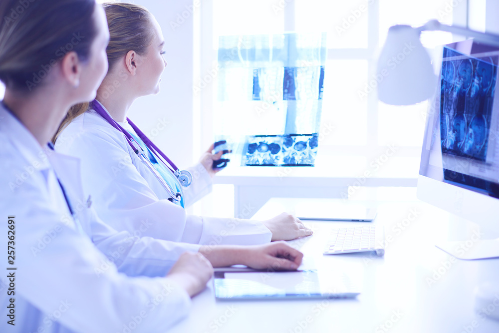 Close up shoot of doctor with tablet and colleague with x-ray on the background. Close up shoot of doctor with tablet and colleague with x-ray on the background.