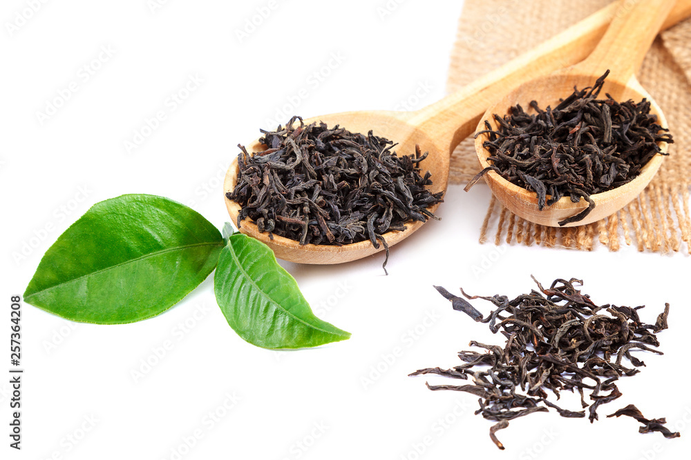 Black tea in a wooden spoon isolated on white background Black tea in a wooden spoon isolated on white background