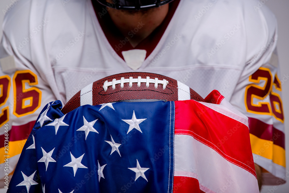 Fototapeta premium American football ball with national flag.