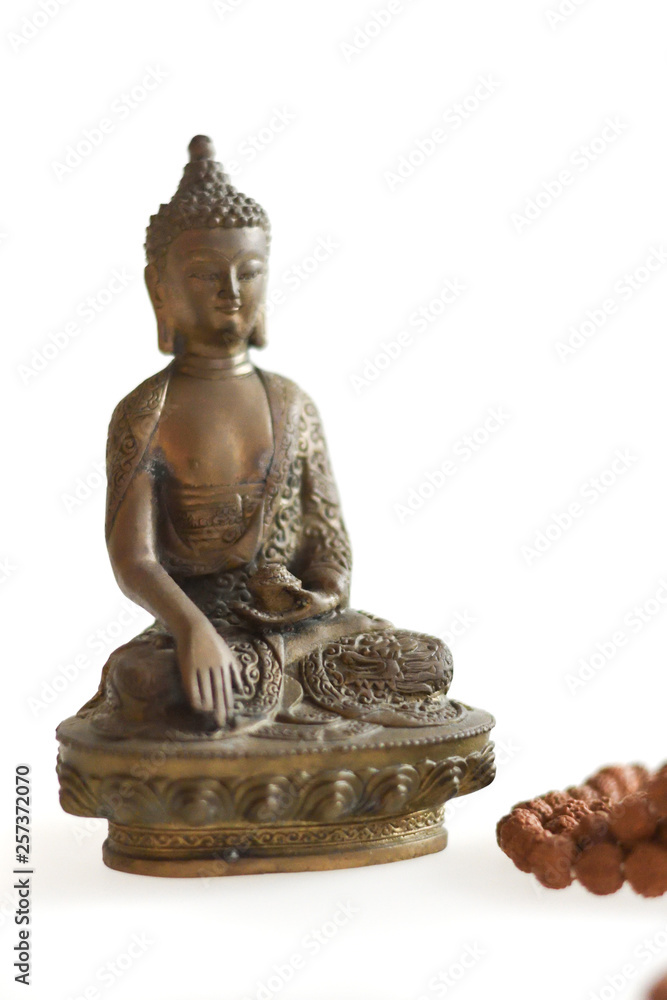 Copper Buddha on a white background