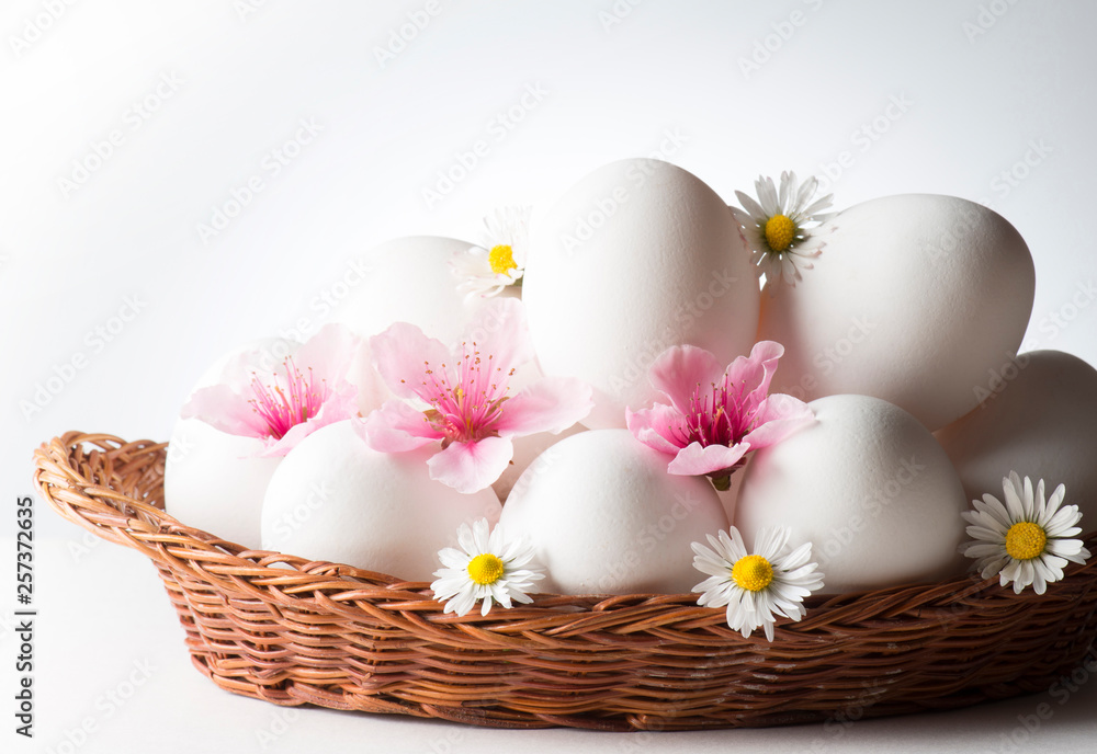 basket with white eggs and flowers basket with white eggs and flowers