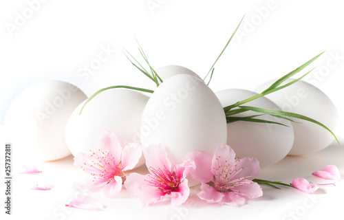 white eggs with peach flowers on the white background