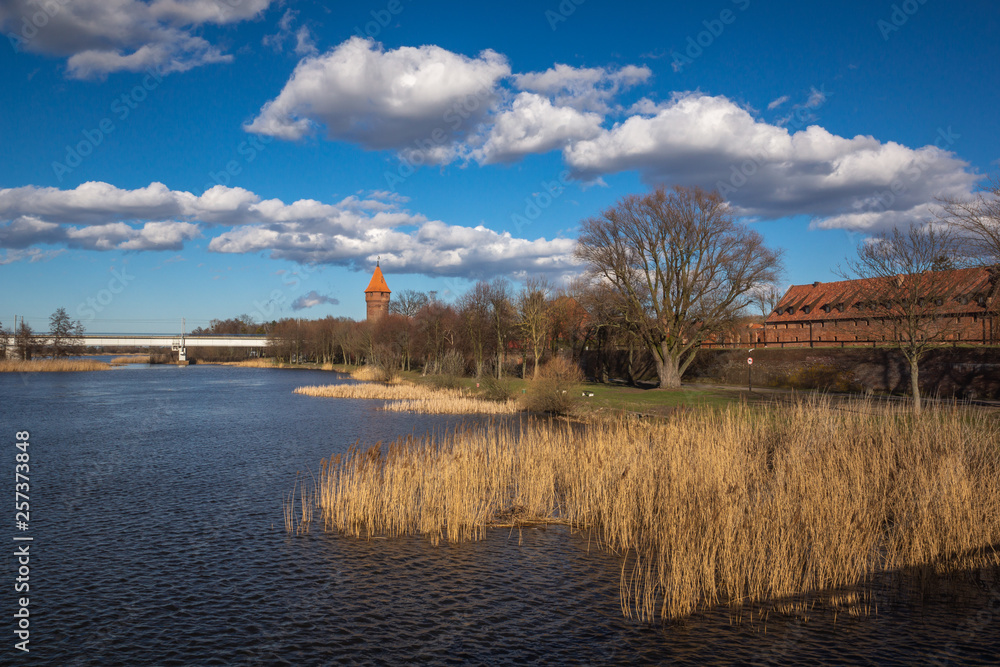 Fototapeta premium Maslankowa Tower and Nogat river in Malbork, Pomorskie, Poland