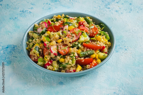 Quinoa salad with green leaves and vegetables. 