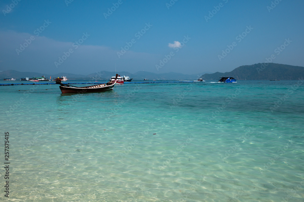 some of tourists' speed boats and local boats on the sea at Koh Hey or Coral Island, Rawai, Phuket in high season
