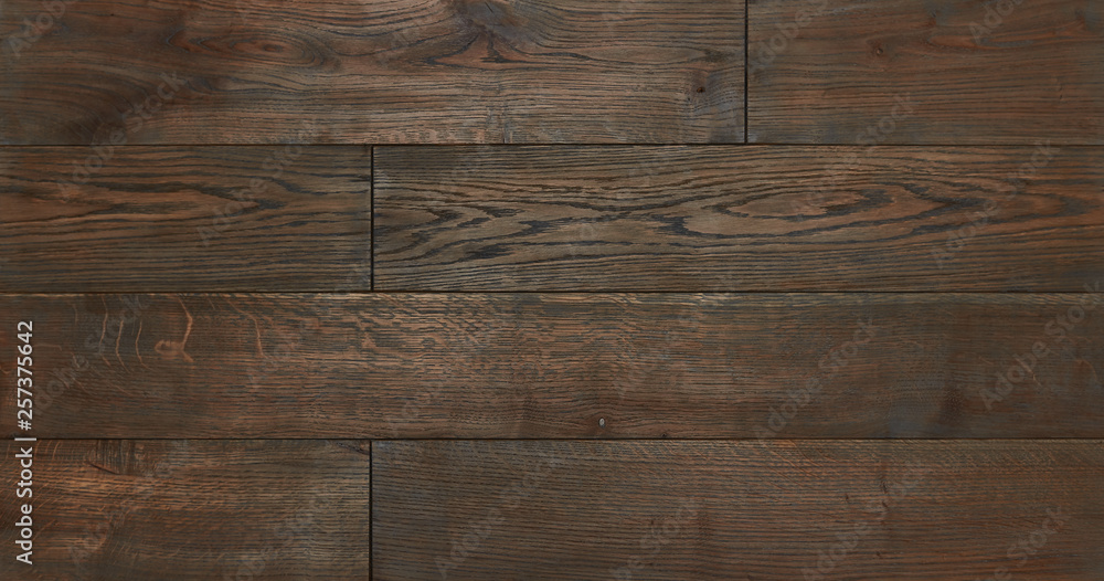 Naklejka premium parquet from solid wood. sample of parquet. texture or background. wood texture. board. painted with natural oil. wax. mastic. imitation of valuable species of wood.