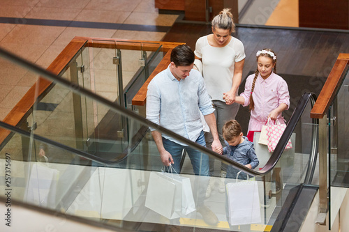 Familie beim Shopping auf einer Rolltreppe