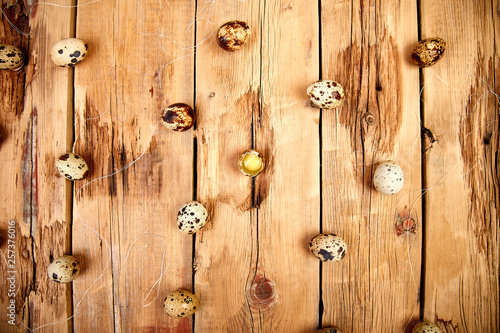 Quail eggs on wooden background. Happy easter.