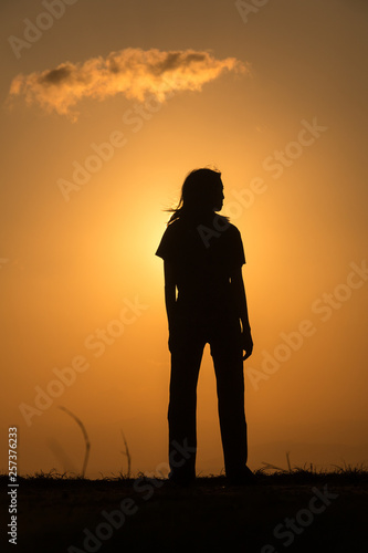 Silhouette woman at sunset.