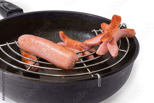 Photography Fried vienna sausages in the frying pan with lattice-insert