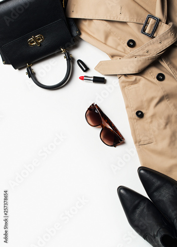 Women fashion clothes and accessories flat lay, beige trench coat with bag, glasses and western boots