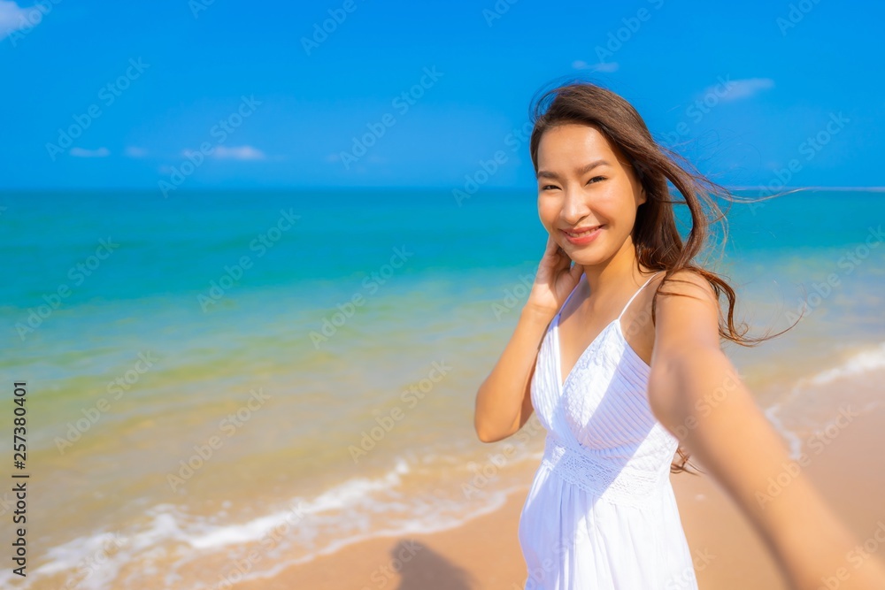 Portrait beautiful young asian woman happy smile leisure on the beach sea and ocean Portrait beautiful young asian woman happy smile leisure on the beach sea and ocean