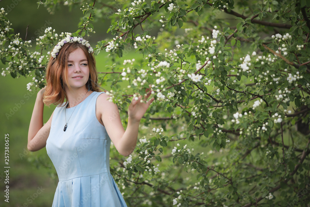 Girl in blue dress in green park Girl in blue dress in green park
