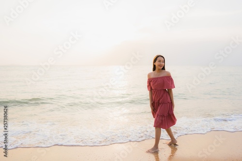 Portrait beautiful young asian woman happy smile leisure on the beach sea and ocean