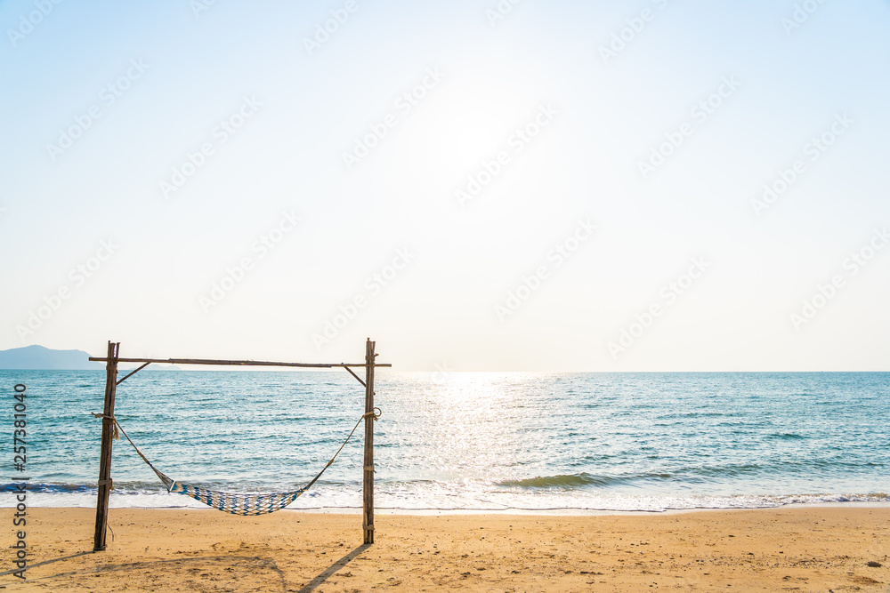 Empty hammock swing on the beautiful beach and sea