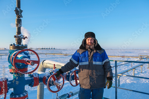 The mechanic - the repairman , operator production gas, Oil, gas industry. gas conditioning equipment and valve armature photo