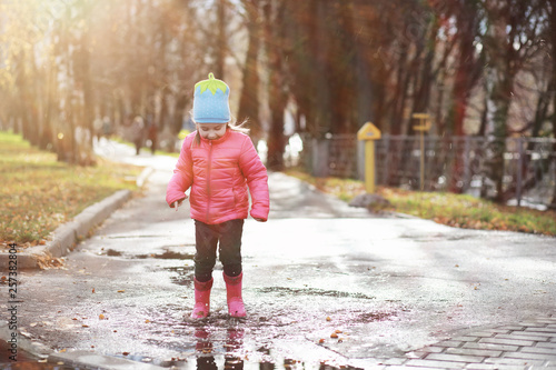 Children walk in the autumn park © alexkich