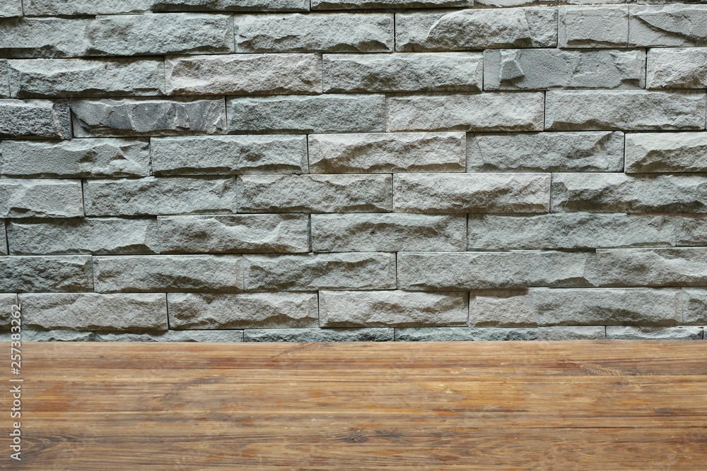 Gray block wall and wooden table Gray block wall and wooden table