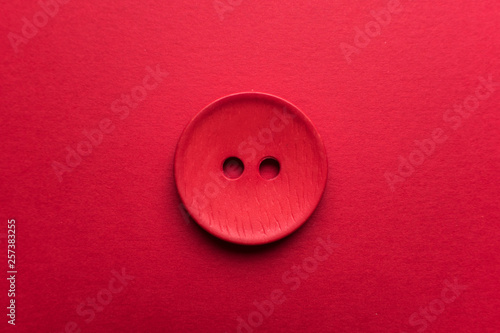 Red button on red background 