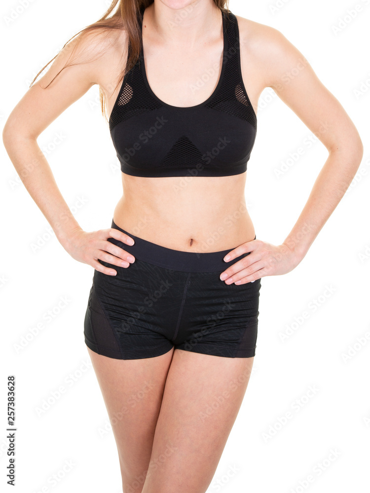 Slim body of a young woman in sport wear activewear on white background Slim body of a young woman in sport wear activewear on white background