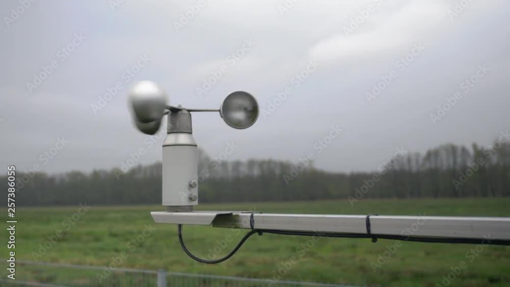 medium shot of an anemometer spining in the wind at an environmental measuring site. medium shot of an anemometer spining in the wind at an environmental measuring site.