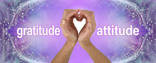 Purple Heart Hands Gratitude Attitude Banner  - female hands making a heart shape with the words GRATITUDE  ATTITUDE either side on a wide purple background with sparkling border photo
